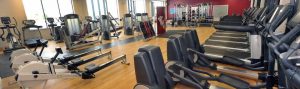 Gym equipement and exercise machines in a brightly lit room